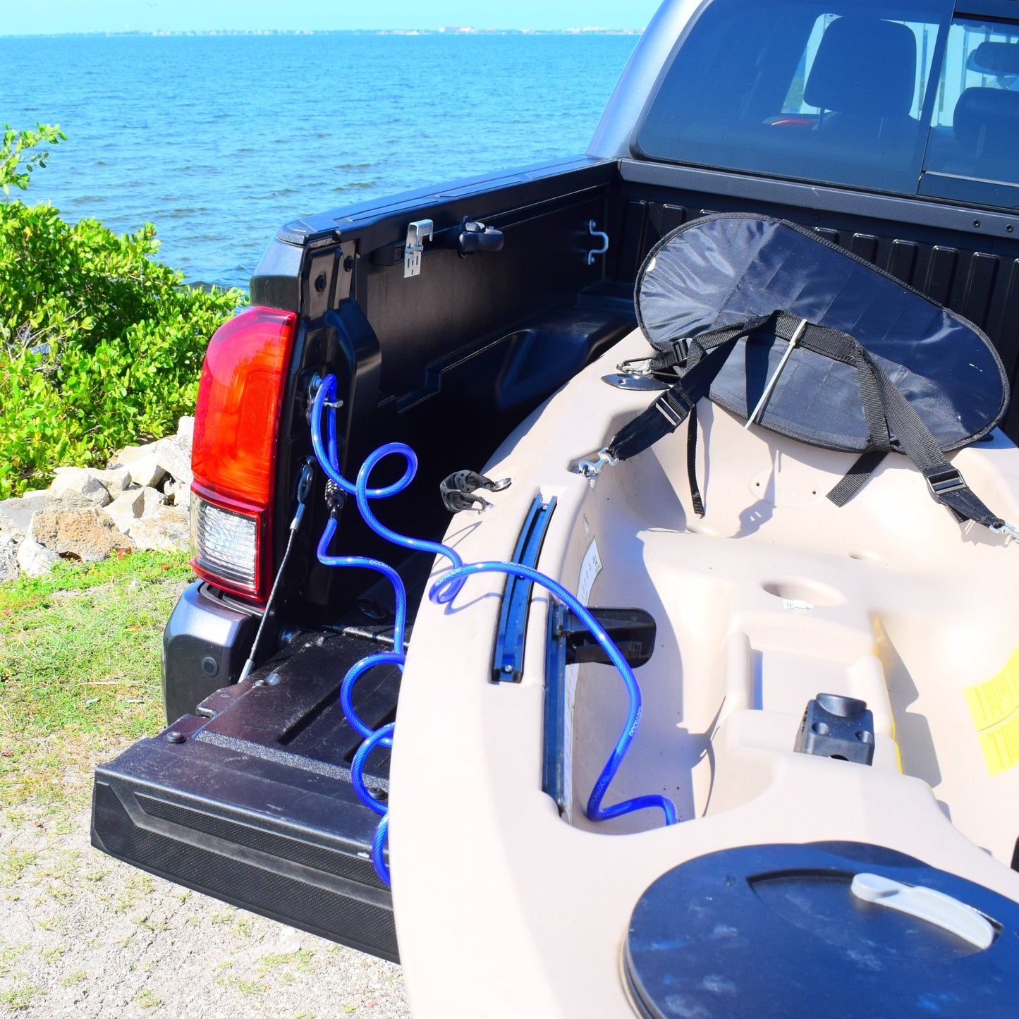DocksLocks kayak lock securing a kayak in a truck bed near the water